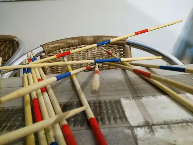 Giant Mikado sticks, longer than an arm, scattered across a cafe table