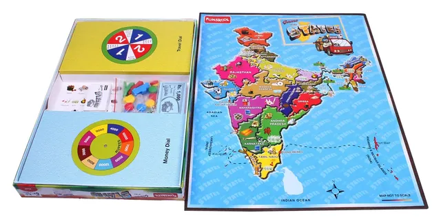 The opened game: a map of India gameboard beside the box insert with the Travel and Money spinner dials