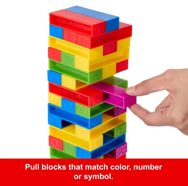 A hand pulling a purple block out of the middle of the UNO Stacko tower