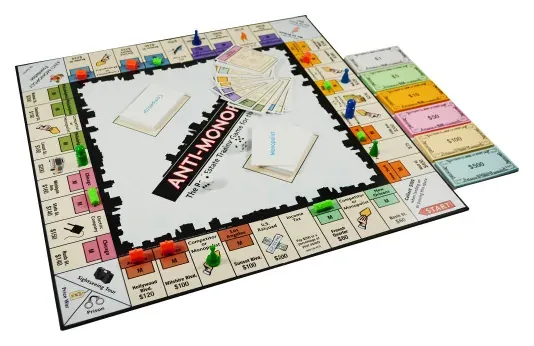 The Anti-Monopoly board with pawns, houses, cards and money during a game