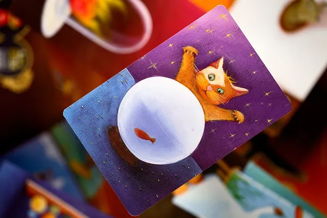 A Dixit card showing a cat gazing at a glowing ball