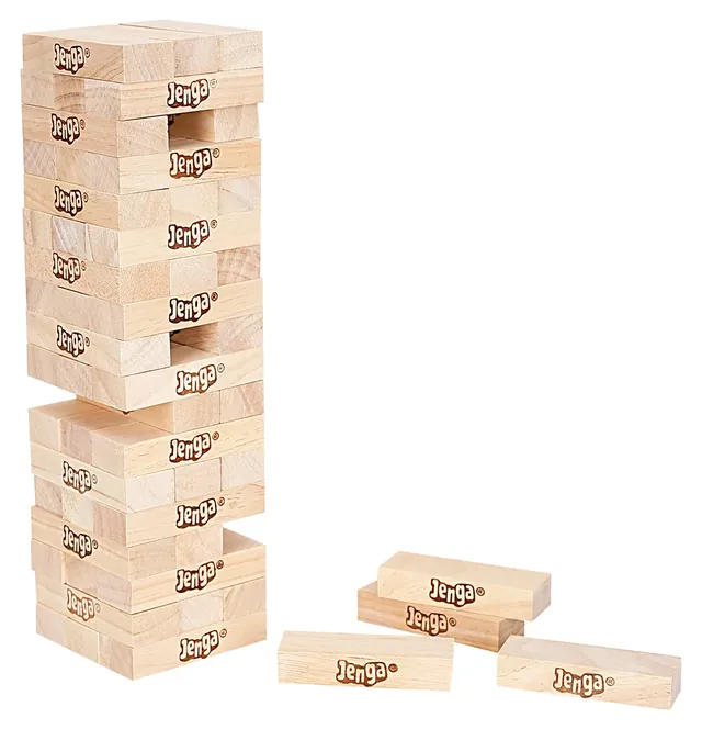 A Jenga tower with gaps where blocks have been pulled, and three blocks lying beside it