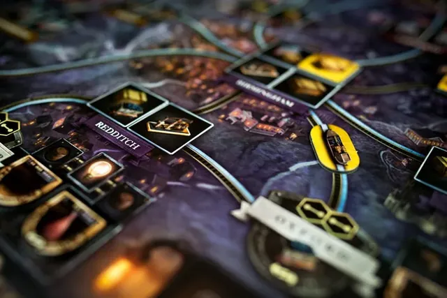 Close-up of the Brass: Birmingham board with industry tiles, canal links and town names on the night-side art